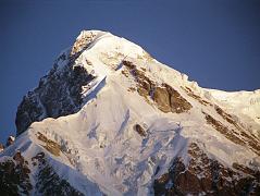 10 Rakhiot Peak East Face Close Up From Tarashing At Sunrise Rakhiot Peak South Face to the left in shadow and East Face shining in the early morning sun, seen from Tarashing. Rakhiot Peak (7070m) was first climbed on July 16, 1932 by Peter Aschenbrenner and Herbert Kunigk while attempting Nanga Parbat. Hermann Buhl climbed the summit needle of Rakhiot Peak on June 21, 1953 on the way to the first ascent of Nanga Parbat.